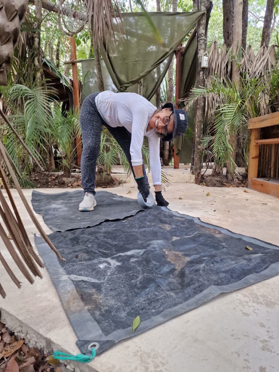Edith preparing a tarp for the jungle cabin roof